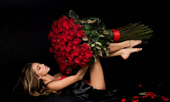 美浪漫的女人红色的玫瑰花情人节时尚工作室肖像美丽的女孩礼物爱最喜欢的花
