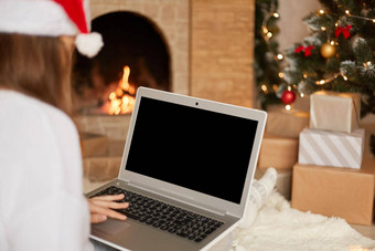 照片迷人的夫人坐着地板上持有移动PC空白屏幕穿红色的圣诞<strong>老人老人</strong>他白色毛衣摆姿势装饰x-mas<strong>生活</strong>房间复制空间