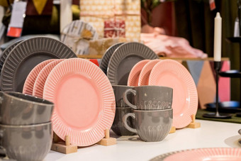 灰色的粉红色的表格设置现代风格服务商店目录<strong>热饮料</strong>茶咖啡时尚的优雅的陶瓷餐具商店货架上厨房餐具温柔的柔和的颜色
