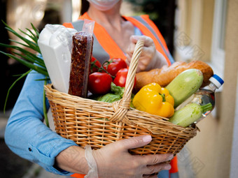 戴着手套女人持有柳条篮子完整的蔬菜至关重要的食物项目<strong>志愿者</strong>交付食物包期流感大流行