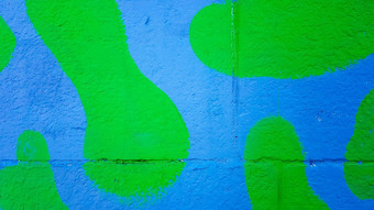 混凝土墙画绿色蓝色的伪装污渍油漆石头墙色彩斑斓的背景复制空间