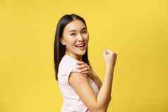 科维德医疗保健医疗概念快乐的亚洲女孩显示手臂补丁冠状病毒疫苗接种拍摄疫苗站快乐黄色的背景