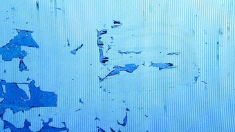 不均匀波浪塑料表面仍然是古里古怪的电影纸摘要过时了蓝色的背景复制空间设计粮食蓝色的油漆墙背景纹理