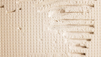 胶水瓷砖齿轮模式安装瓷砖表面墙覆盖胶粘剂粘贴铺设瓷砖装饰石头修复工作改造概念