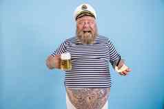 快乐的大小人水手西装持有管啤酒光蓝色的背景