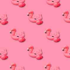 粉红色的火烈鸟单色背景游泳池玩具形状粉红色的火烈鸟无缝的模式火烈鸟充气减少前视图平躺
