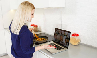 美丽的女孩学习烹饪健康的食物在线互联网移动PC灰色的厨房表格