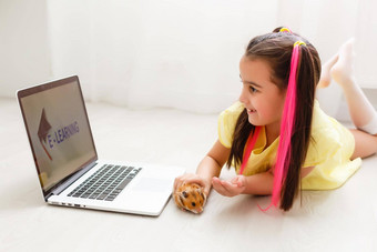 快乐的年轻的女孩宠物仓鼠移动PC电脑研究在线电子<strong>学习</strong>系统首页距离<strong>远程学习</strong>