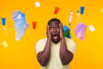 世界环境一天塑料回收问题环境灾难概念吓坏了男人。黄色的背景垃圾