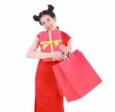 快乐女人持有购物袋红色的礼物盒子概念中国人一年庆祝活动孤立的白色背景