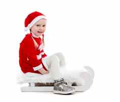 快乐的女孩圣诞老人西装坐着雪橇