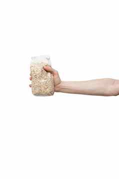 塑料袋燕麦举行手孤立的白色男人。持有包燕麦片