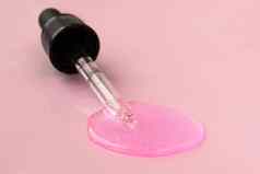 吸管流体透明质酸酸粉红色的背景化妆品医疗保健概念特写镜头