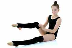 女孩体操运动员黑色的紧身裤体育运动概念