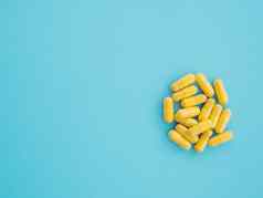 分类黄色的药用制药产品平板电脑药片胶囊蓝色的背景概念医疗保健医学治疗病毒空间文本