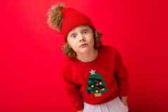 可爱的金发碧眼的男孩温暖的他圣诞节毛衣红色的背景微笑脸