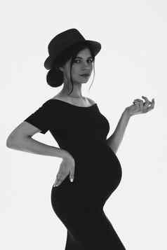 美丽的怀孕了年轻的女孩肚子穿他黑色的衣服期待婴儿时尚的怀孕黑色的白色