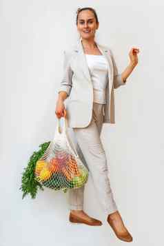 女人光西装持有棉花购物者可重用的网购物袋蔬菜浪费塑料概念复制空间环保网买家