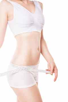 减肥女人测量臀部磁带