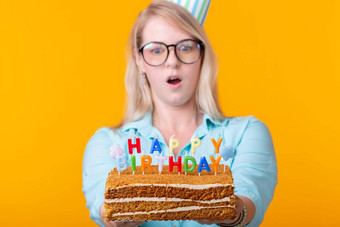 有趣的积极的年轻的女人持有手自制的蛋糕登记快<strong>乐</strong>生日摆姿势黄色的背景概念假期<strong>周年</strong>纪念