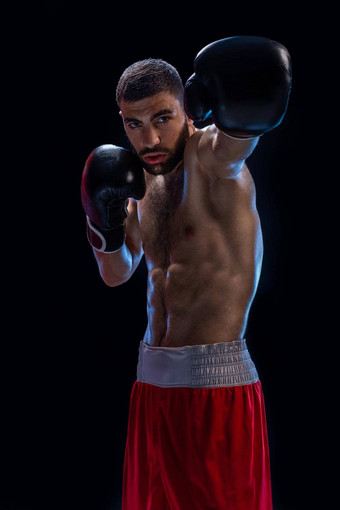 拳击手准备好了交易强大的打击照片肌肉发达的男人。黑色的背景