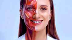 年轻的女人一半脸肌肉结构皮肤模型医疗培训光背景关闭视频脸人类剖面术