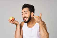 男人。白色t恤苹果手水果健康的食物孤立的背景