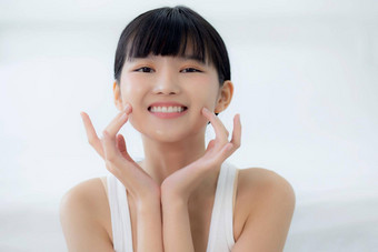 美丽的年轻的亚洲女人化妆化妆品女孩手触摸脸颊脸微笑有吸引力的面部美完美的护肤品健康皱纹皮肤护理健康概念