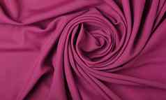 背景粉红色的纺织折叠打褶