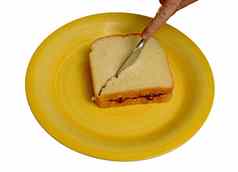 切片花生黄油果冻三明治黄色的板