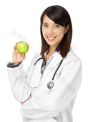 亚洲女医生持有绿色苹果