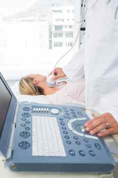 医生执行超声波扫描脖子病人