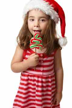 圣诞老人女孩舔圣诞节树棒棒糖糖果