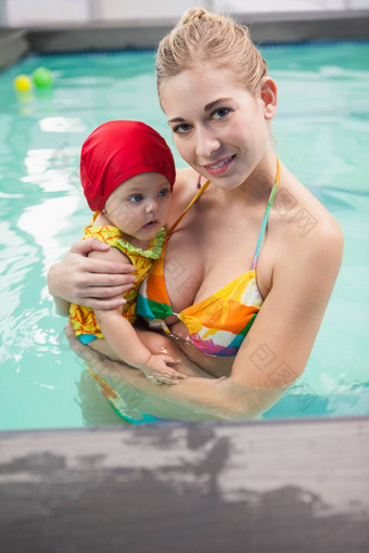 漂亮的妈妈。婴儿游泳池