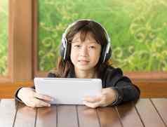 亚洲年轻的女孩听音乐耳机