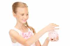 可爱的十几岁的女孩小猪银行钱