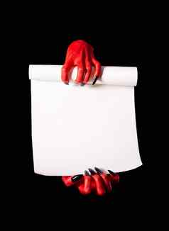红色的魔鬼手黑色的指甲持有空白纸滚动