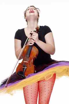 年轻的女小提琴球员色彩斑斓的裙子跳舞