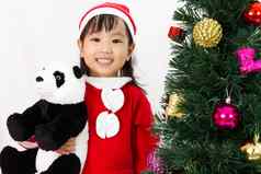 亚洲中国人女孩持有熊猫娃娃摆姿势克里斯特姆