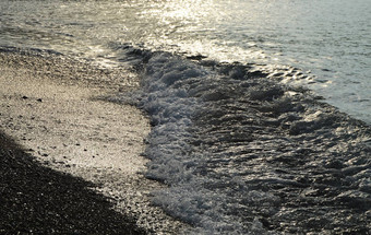 闪亮的银水海卵石海滩早期早....日出