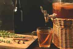 新鲜的自制的红茶菌发酵茶喝Jar水龙头杯瓶黑色的背景