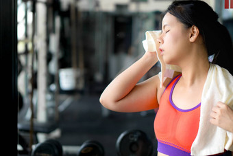 亚洲美女人擦拭<strong>汗水</strong>毛巾健身健身房饮食