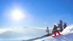 滑雪骑红色的滑雪板坡早....山阳光明媚的天气滑雪冬天体育