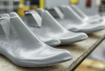 塑料持续制造鞋子行塑料鞋持续制造现代一天鞋子很多塑料鞋木架子上设备鞋设计