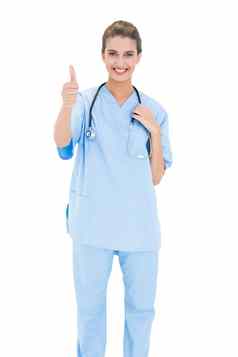 快乐的棕色（的）头发的护士蓝色的实习医生风云给拇指