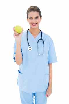 很高兴棕色（的）头发的护士蓝色的实习医生风云持有绿色苹果
