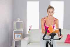 运动集中金发女郎培训锻炼自行车阅读书