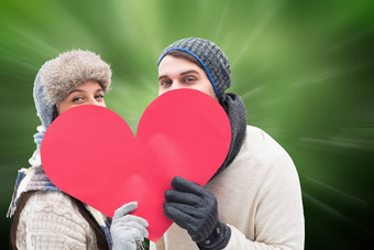 复合图像有吸引力的年轻的夫妇温暖的衣服持有红色的心