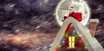 复合图像圣诞老人坐着屋顶小屋