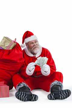 圣诞老人老人坐着礼物计数货币请注意